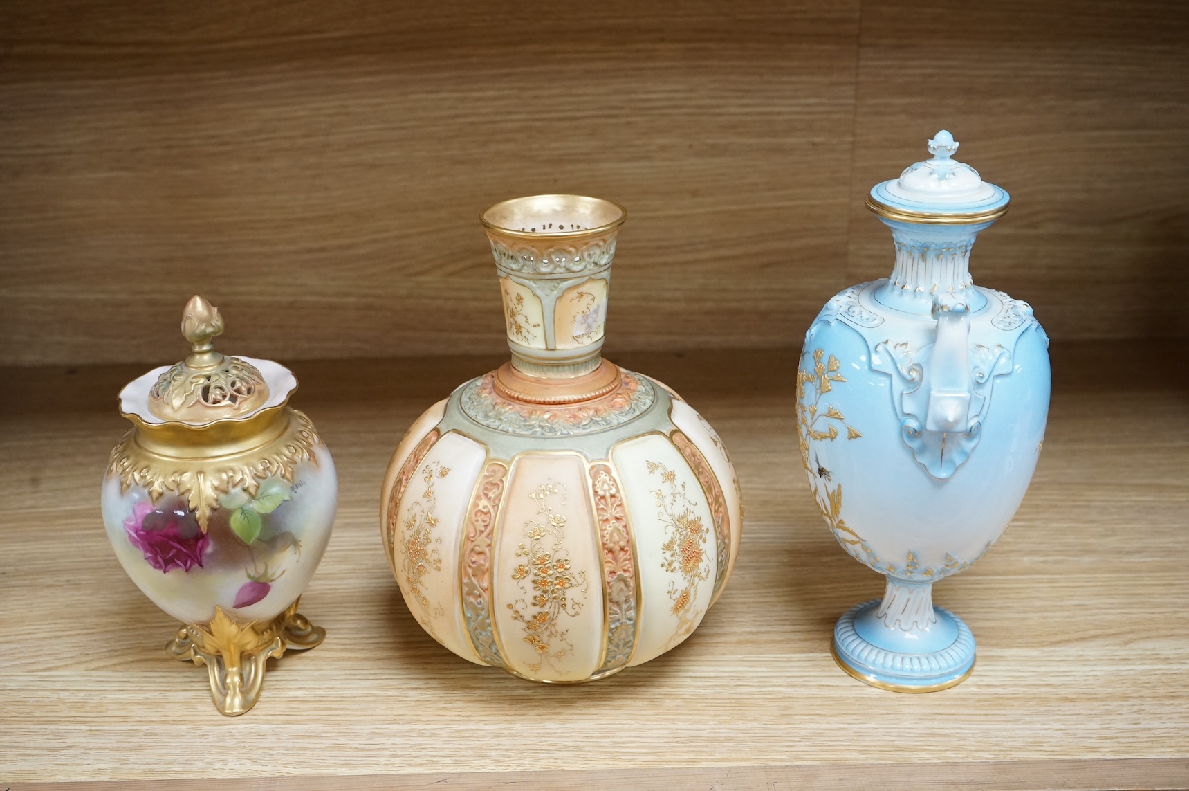 A Royal Worcester vase and cover, shape 1618 decorated with ferns and insects, a similar blush ivory bottle vase and a pot pourri vase and cover decorated with roses, tallest 24cm